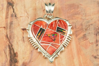 Genuine Spiny Oyster Shell and Black Jade inlaid in Sterling Silver.  Beautiful Fire and Ice Lab Opal Accents with precision inlay.  Free 18" Sterling Silver Chain with purchase of pendant. Designed by Navajo Artist Calvin Begay. Signed by the artist.